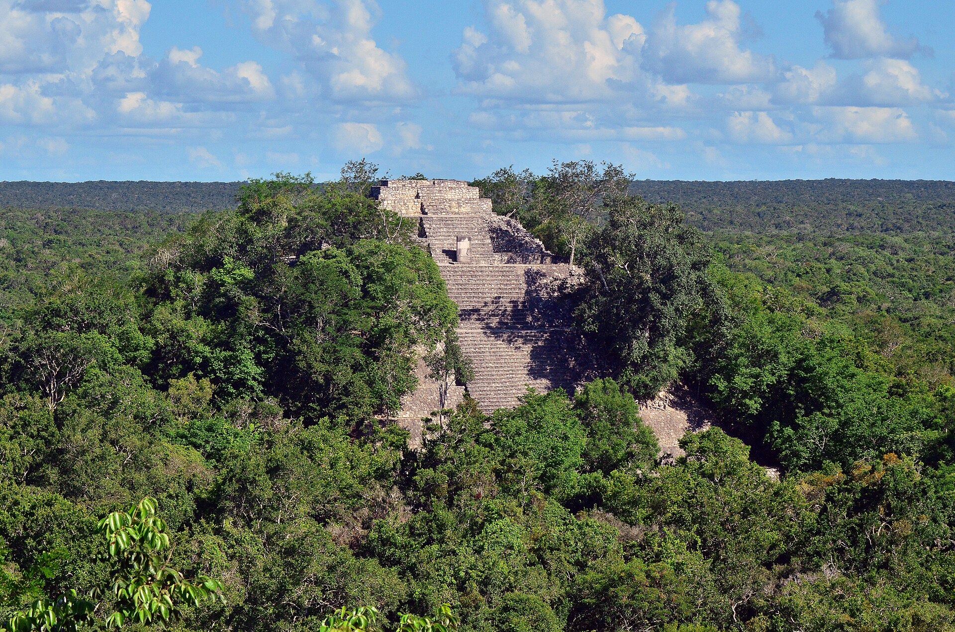 Calakmul Maya pyramids rising above dense tropical forest in Campeche